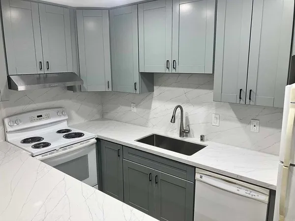 a kitchen with stainless steel appliances granite countertop a sink a stove and a refrigerator