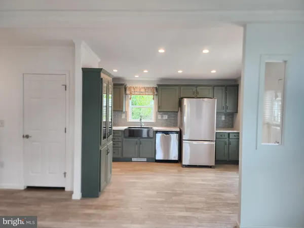 a kitchen with a refrigerator and a stove top oven