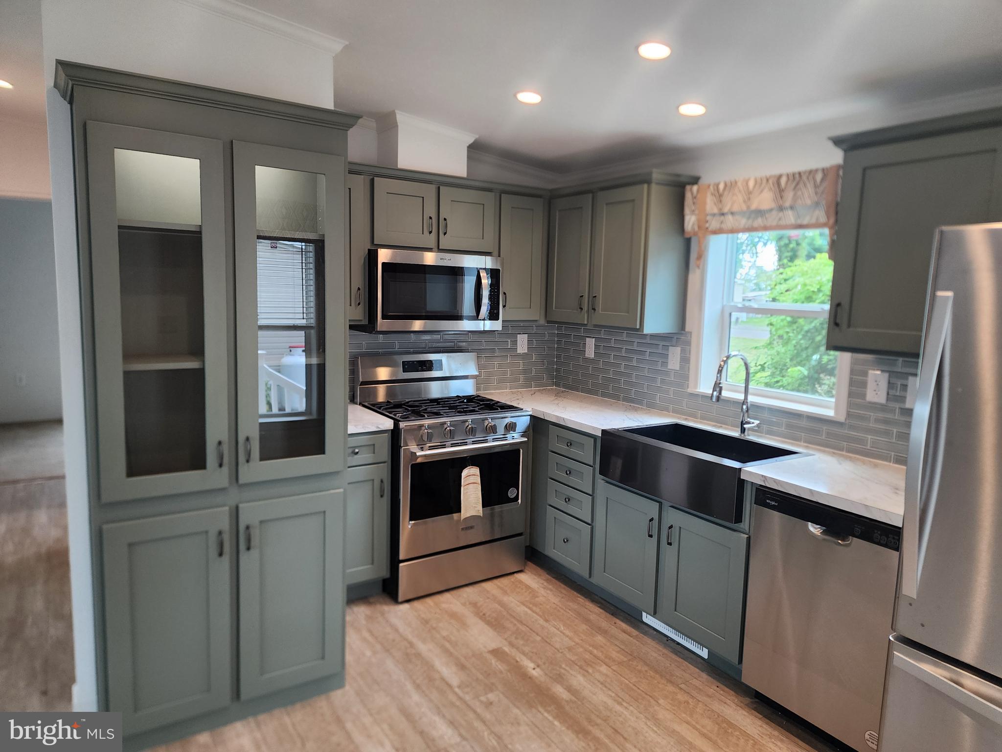 165 West Ridge Pike Limerick, PA 19468 - Photo 3 of 15 a kitchen with kitchen island granite countertop stainless steel appliances cabinets a sink and a window