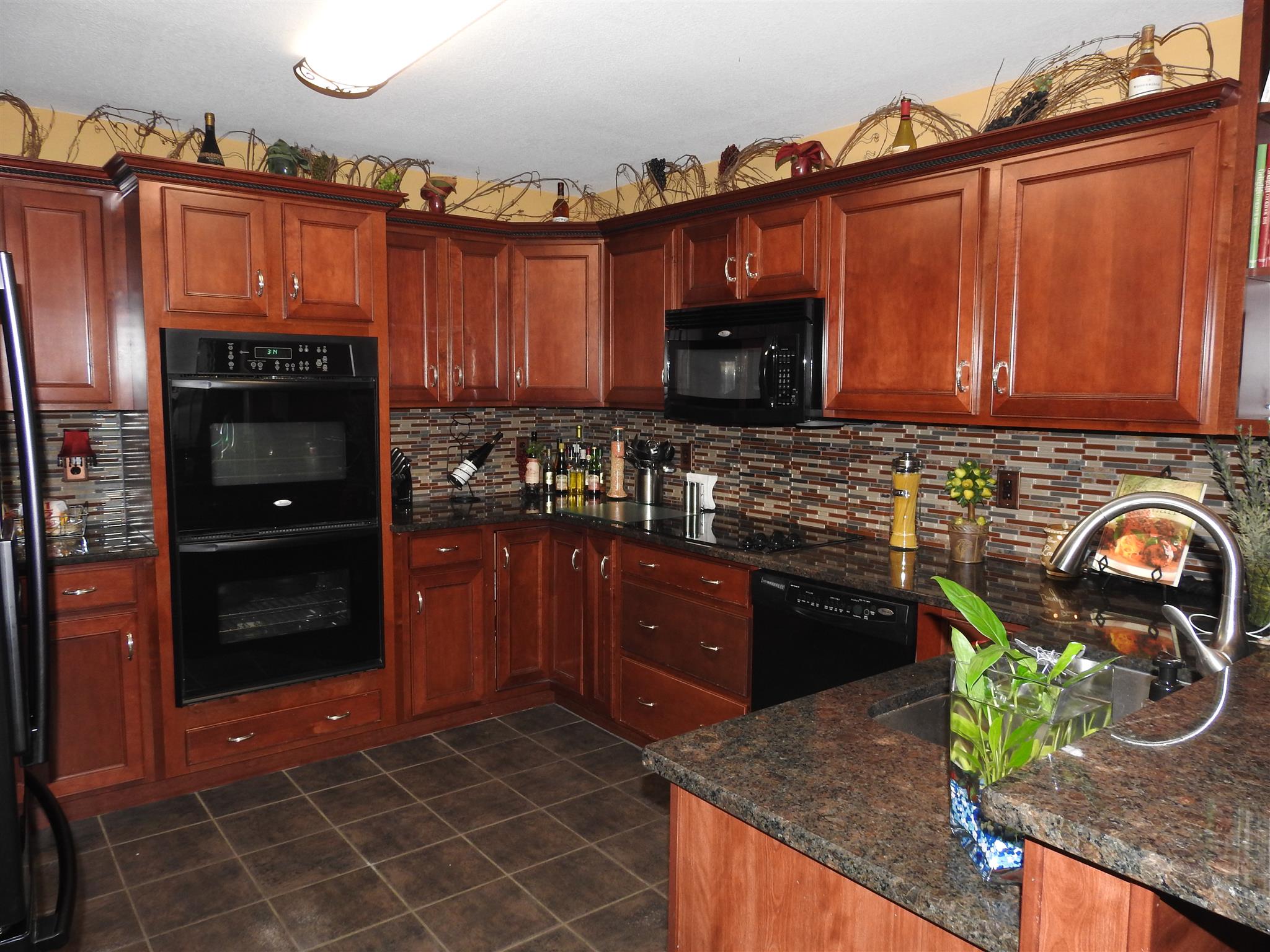 1040 Drake Road Clarksville, TN 37043 - Photo 5 of 29 a kitchen with granite countertop a refrigerator and a stove top oven
