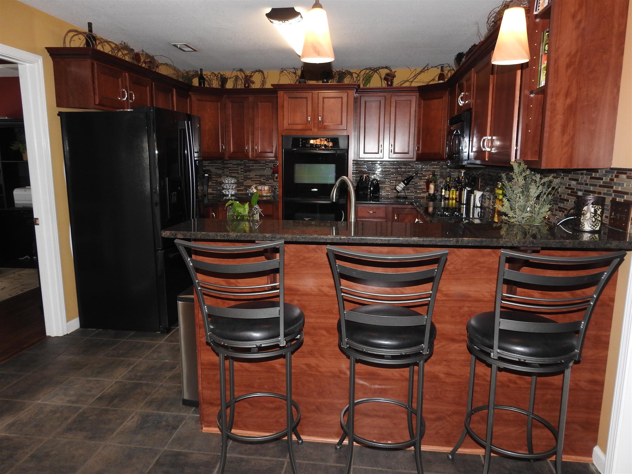 1040 Drake Road Clarksville, TN 37043 - Photo 6 of 29 a kitchen with stainless steel appliances granite countertop a refrigerator and a stove top oven