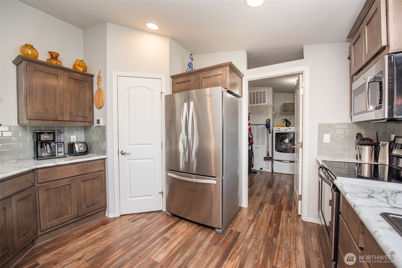 720 West Heritage Loop Sequim, WA 98382 - Photo 10 of 35 a kitchen with stainless steel appliances granite countertop a refrigerator and a sink