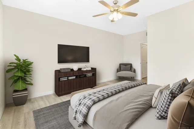 a bedroom with a bed and a flat screen tv