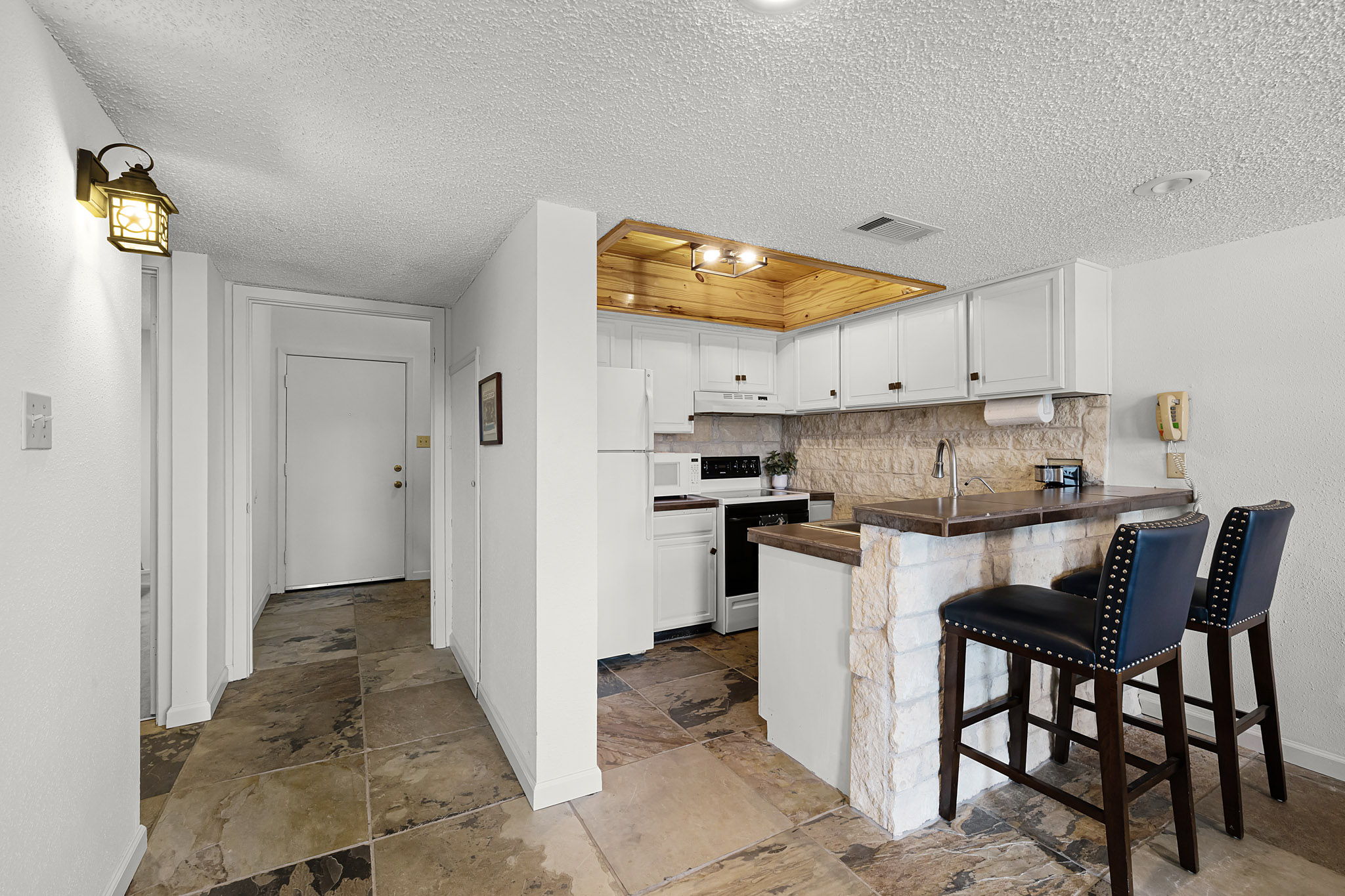 229 Comanche Lane Point Venture, TX 78645 - Photo 10 of 38 a kitchen with a refrigerator and a stove