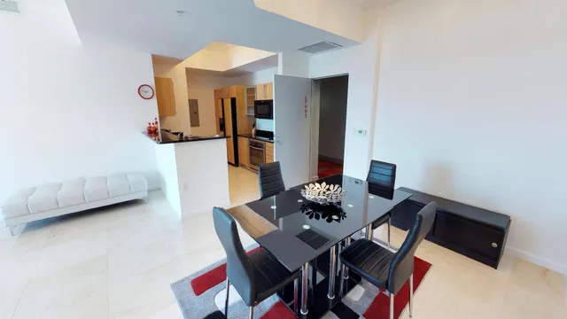 a view of a dining room with furniture and a chandelier