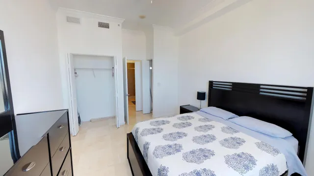 a bedroom with a bed and a dresser