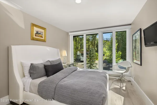 a bedroom with a large bed and a large window