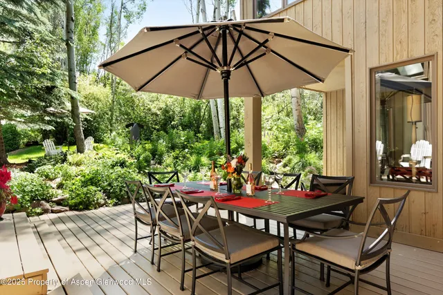 a view of an outdoor sitting area with furniture and umbrella