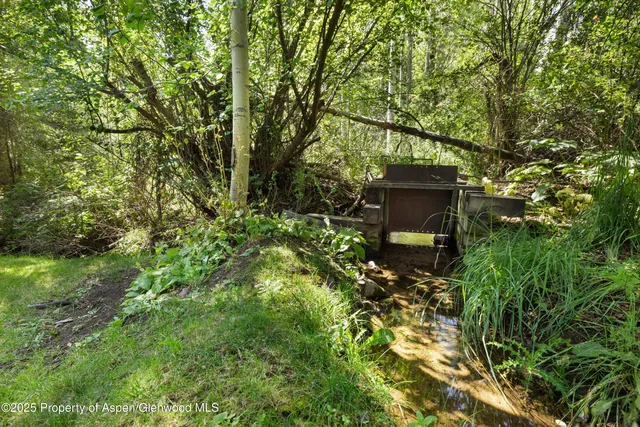 a backyard of a house with lots of green space and garden