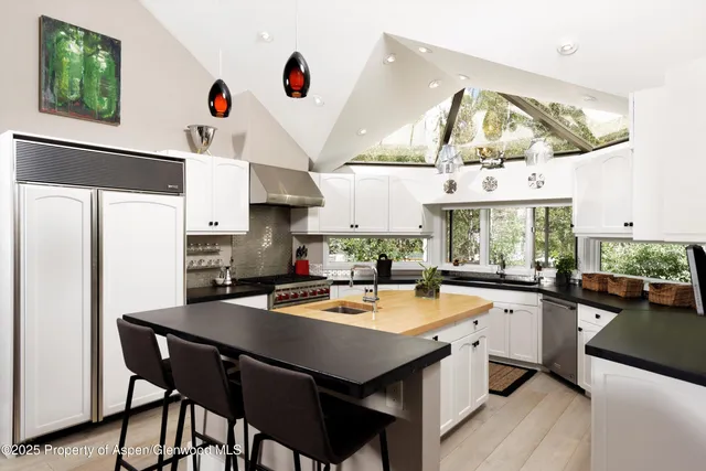 a kitchen with a table chairs stove and cabinets
