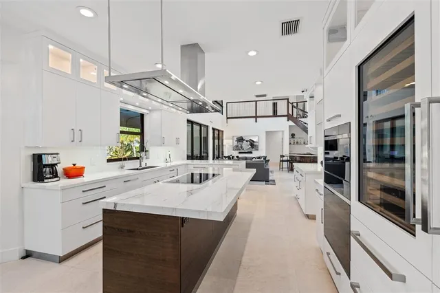 a kitchen with stainless steel appliances kitchen island granite countertop a sink and cabinets