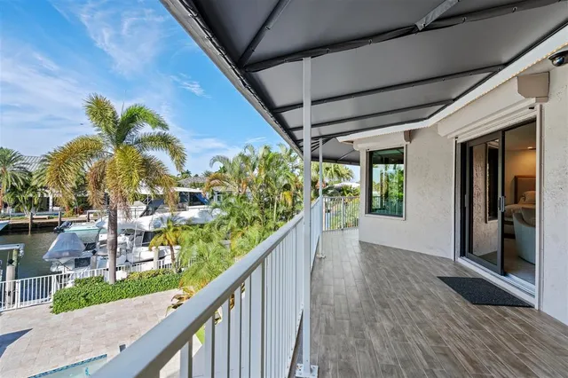 a view of balcony with wooden floor and fence