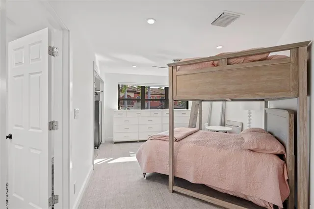 a bedroom with a large bed and a painting on the wall