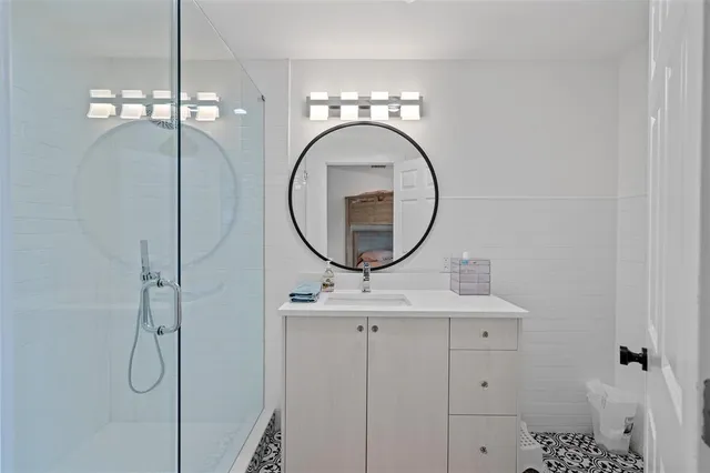 a bathroom with a sink a mirror and vanity