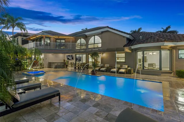 a view of a house with swimming pool and sitting area