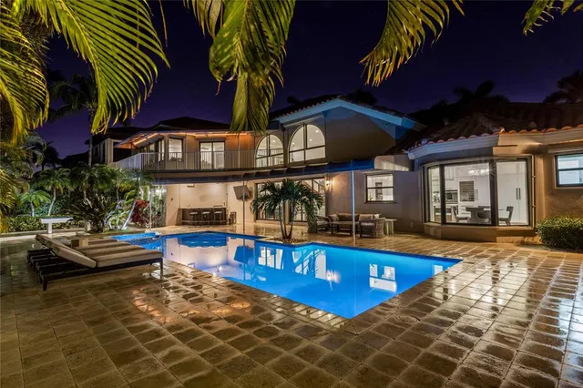 a view of a house with swimming pool and sitting area