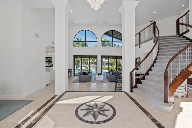 a view of a livingroom with furniture staircase and kitchen view