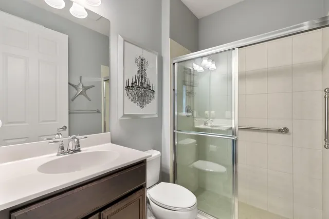 a bathroom with a sink toilet vanity and shower