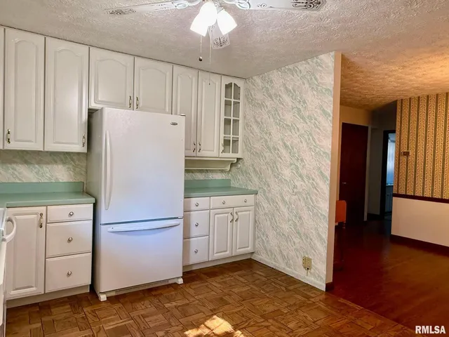 a white refrigerator freezer sitting in a kitchen