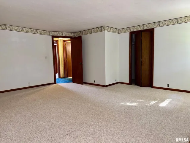 a view of an empty room with a fireplace