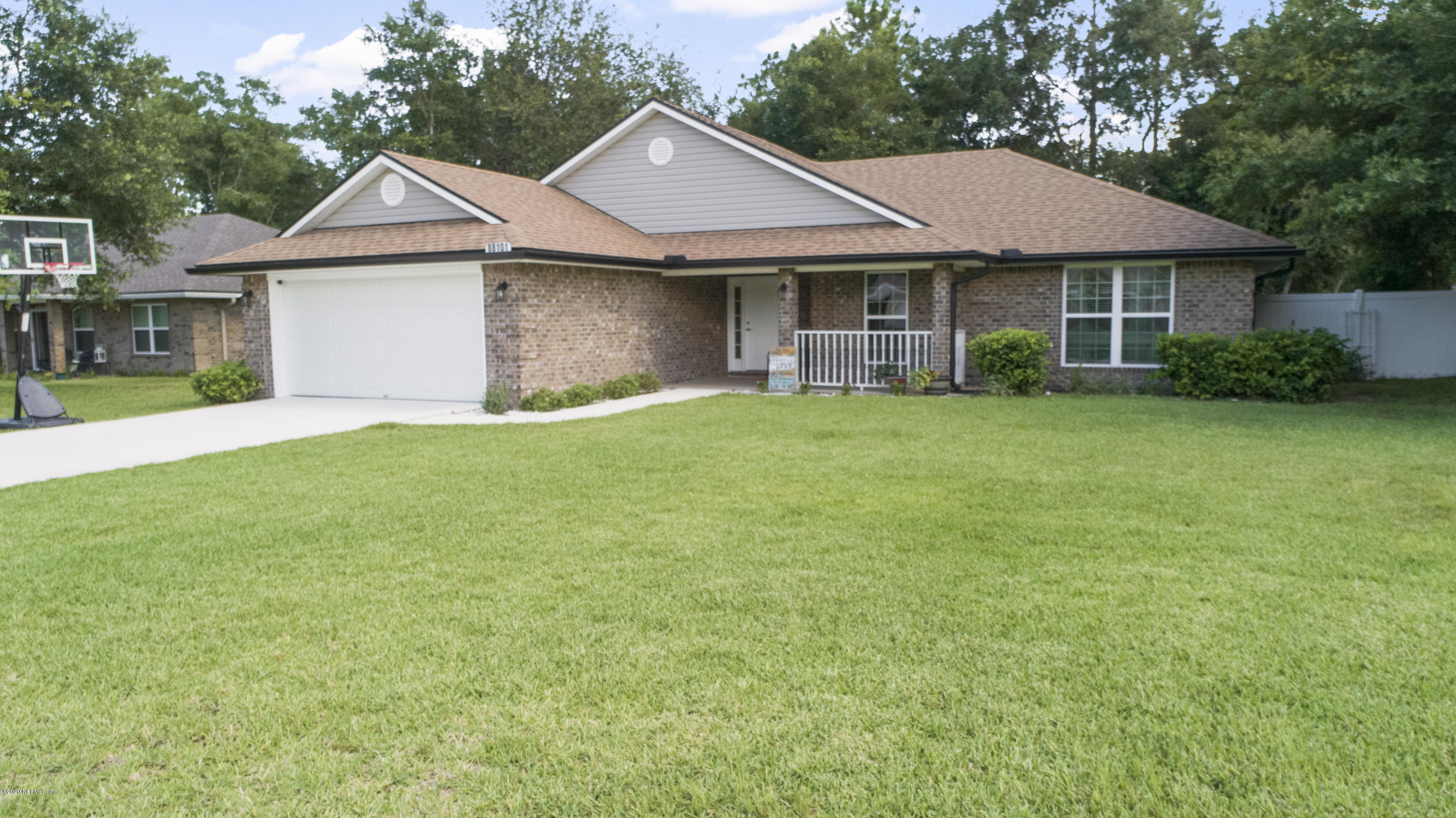 a front view of a house with a garden and yard