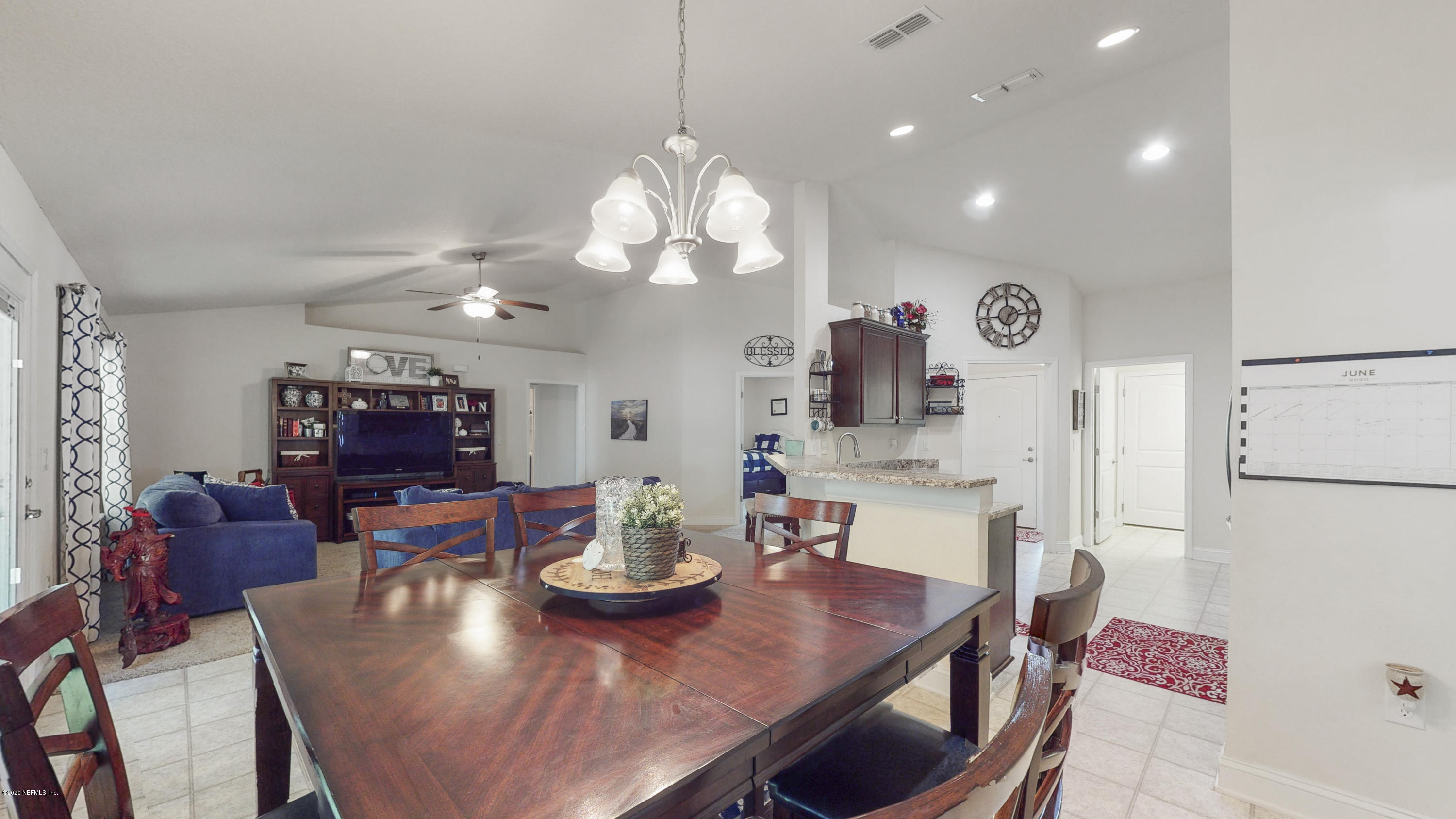 88101 Maybourne Road Yulee, FL 32097 - Photo 11 of 22 a view of a dining room with furniture and a chandelier
