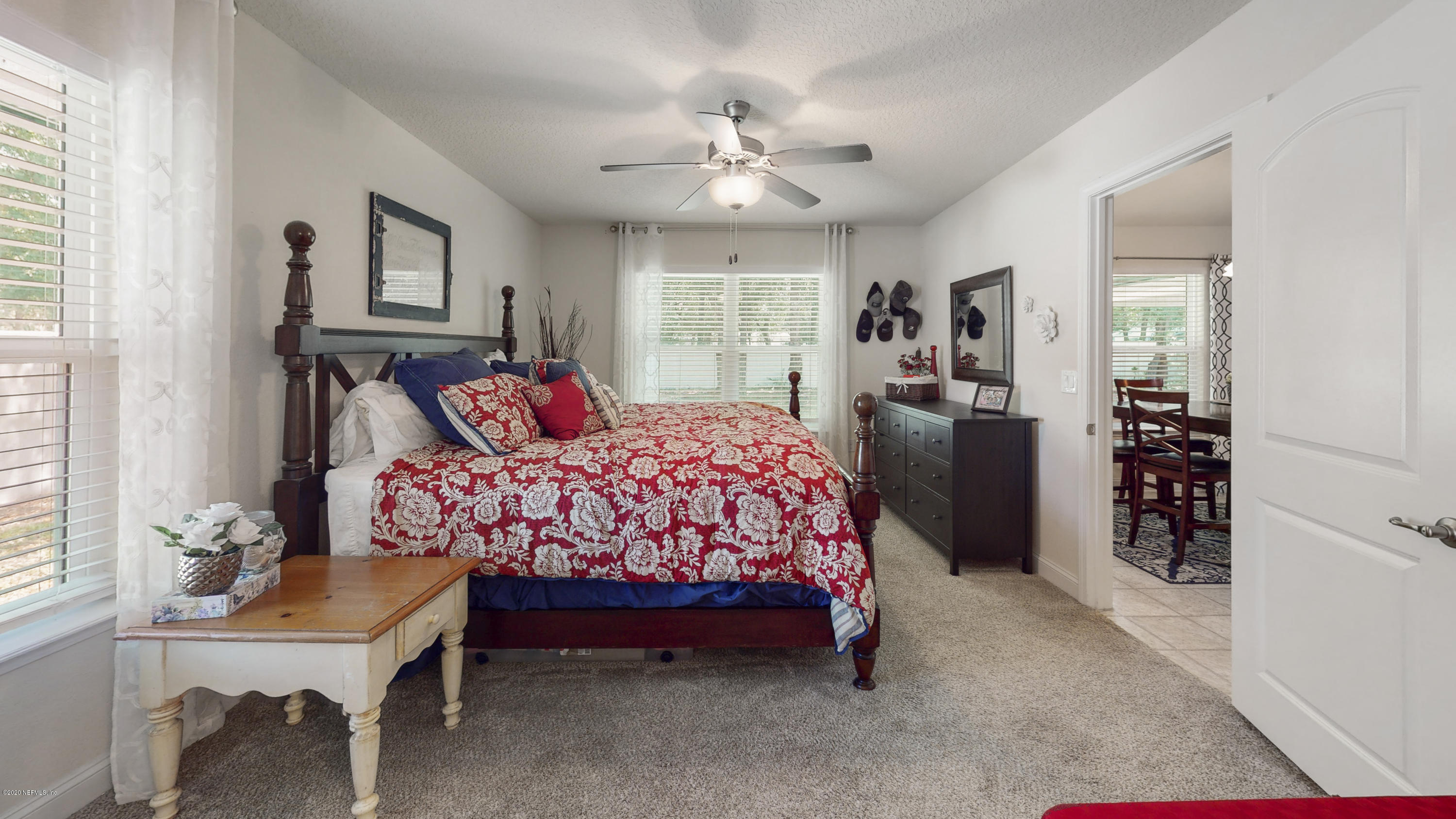 88101 Maybourne Road Yulee, FL 32097 - Photo 12 of 22 a bedroom with a bed and a chandelier