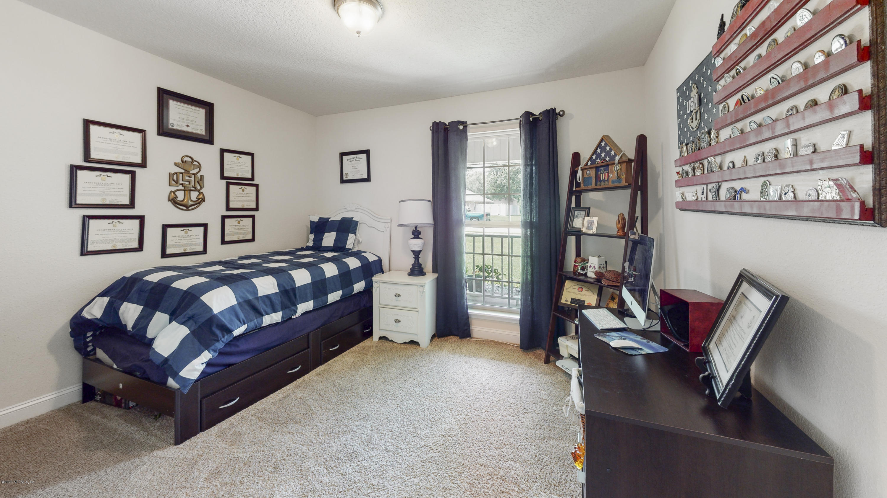 88101 Maybourne Road Yulee, FL 32097 - Photo 16 of 22 a bedroom with furniture and a book shelf