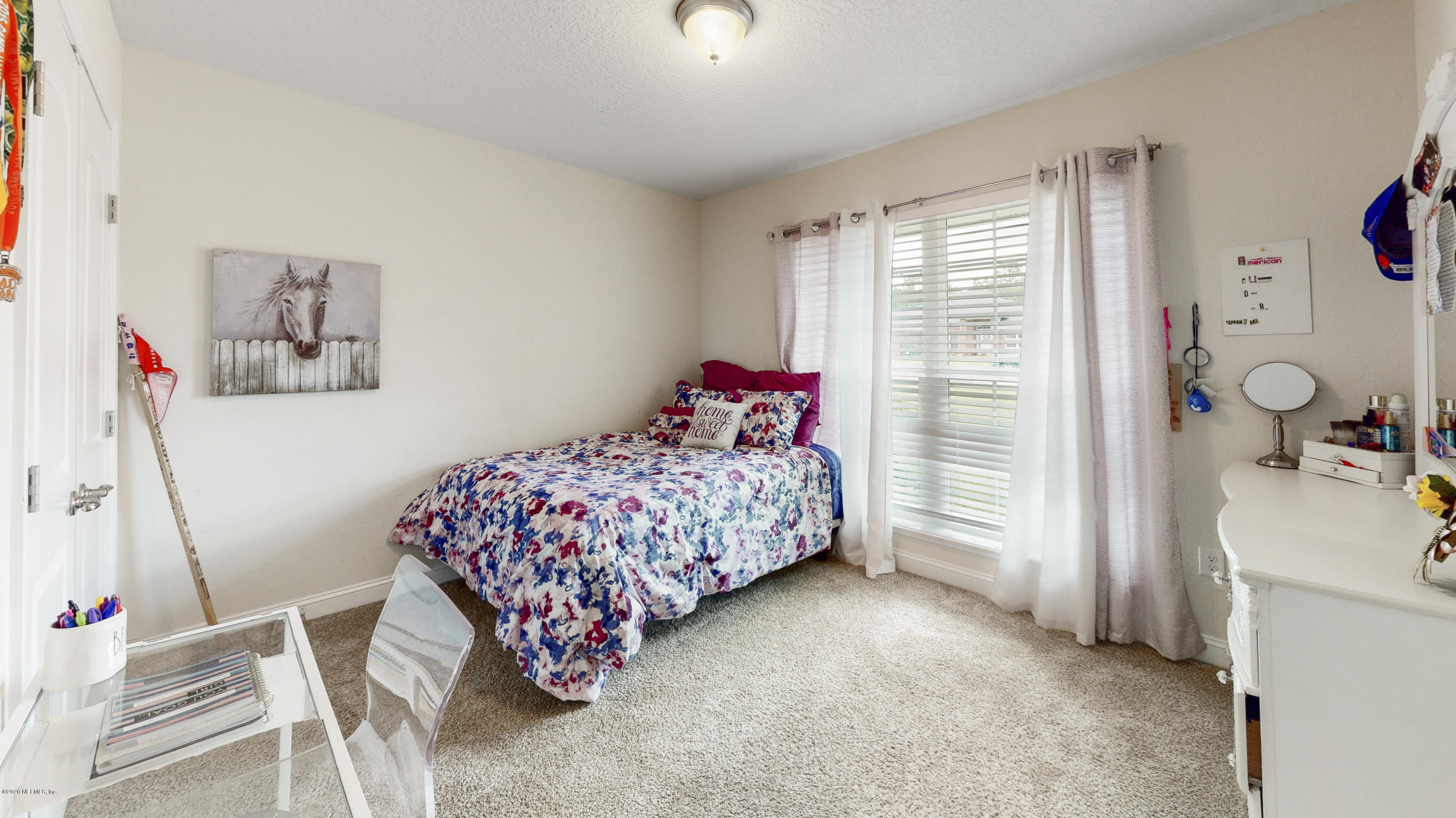 88101 Maybourne Road Yulee, FL 32097 - Photo 17 of 22 a bedroom with a bed and a window