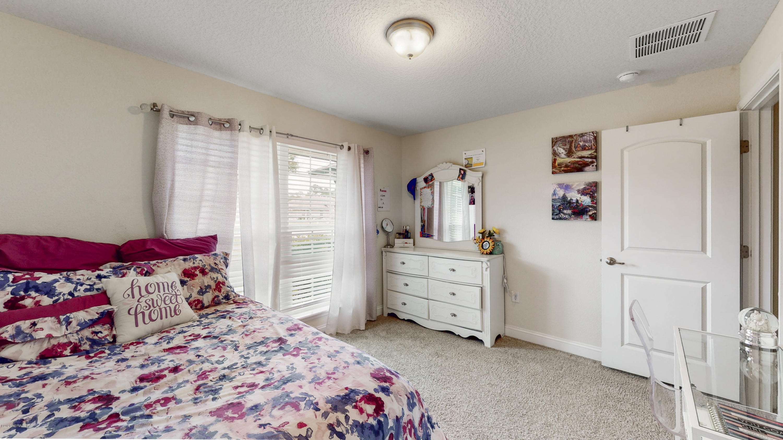88101 Maybourne Road Yulee, FL 32097 - Photo 18 of 22 a bedroom with a bed and a window