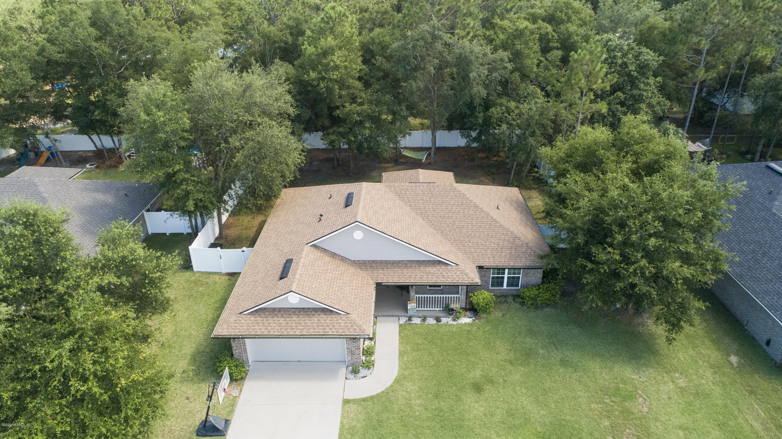 88101 Maybourne Road Yulee, FL 32097 - Photo 2 of 22 an aerial view of a house with swimming pool and garden