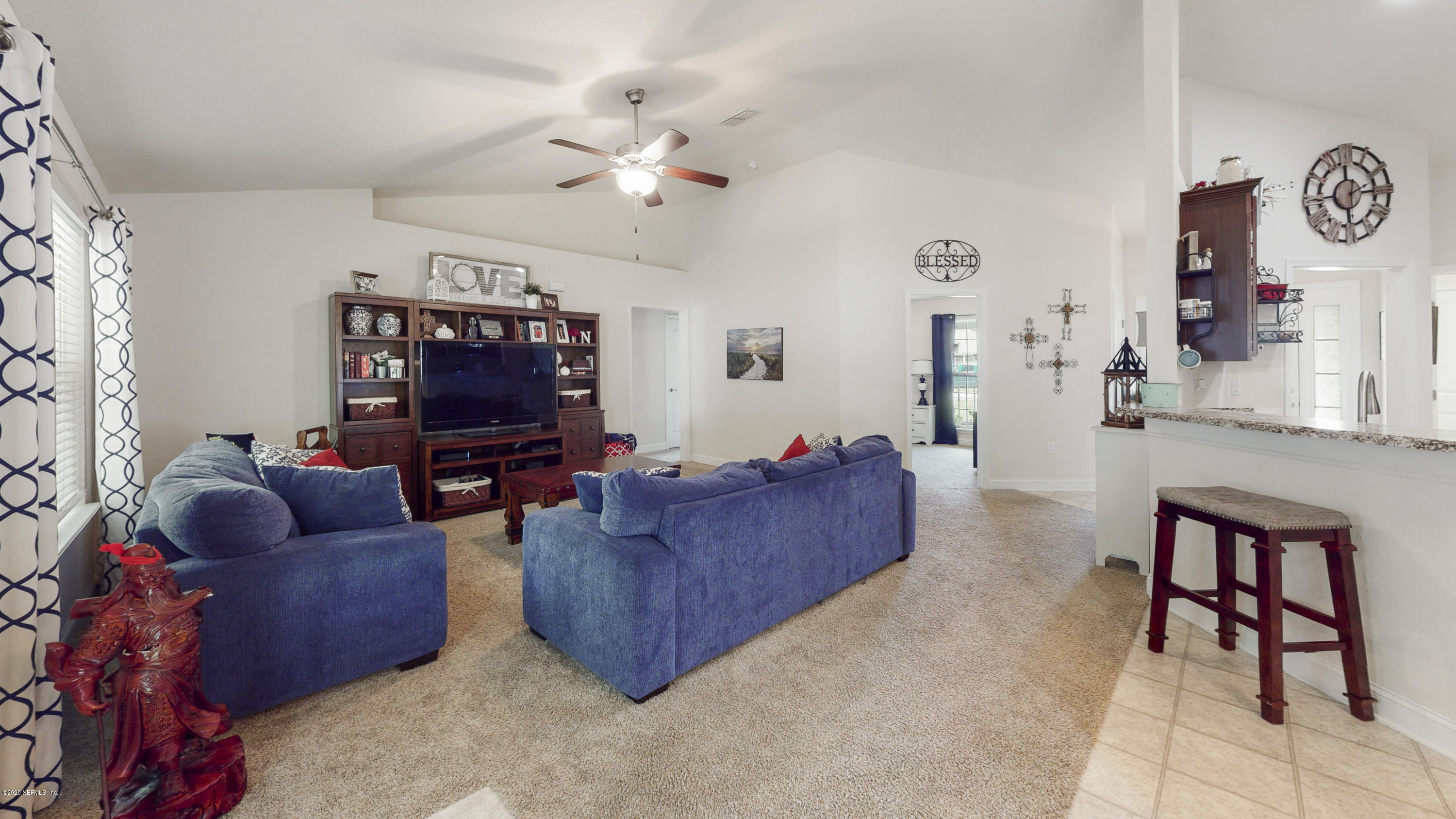 88101 Maybourne Road Yulee, FL 32097 - Photo 5 of 22 a living room with furniture and a flat screen tv