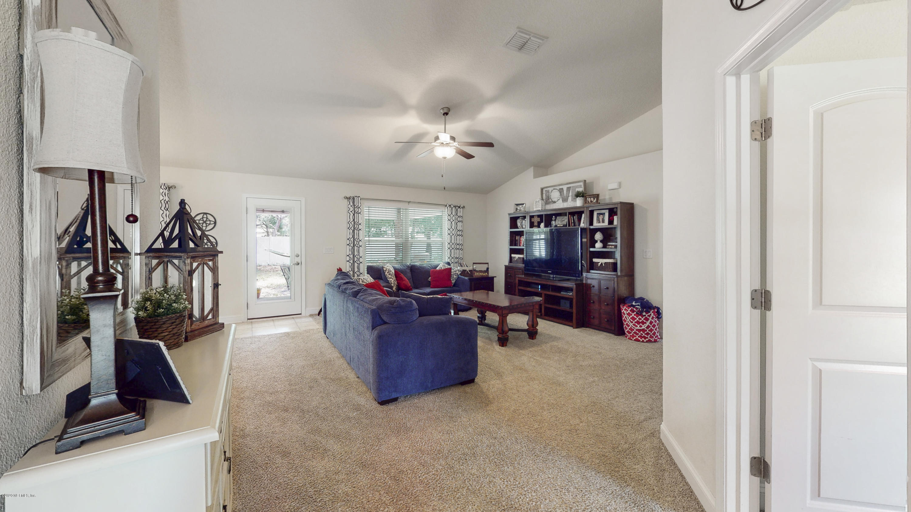 88101 Maybourne Road Yulee, FL 32097 - Photo 6 of 22 a living room with furniture and a flat screen tv