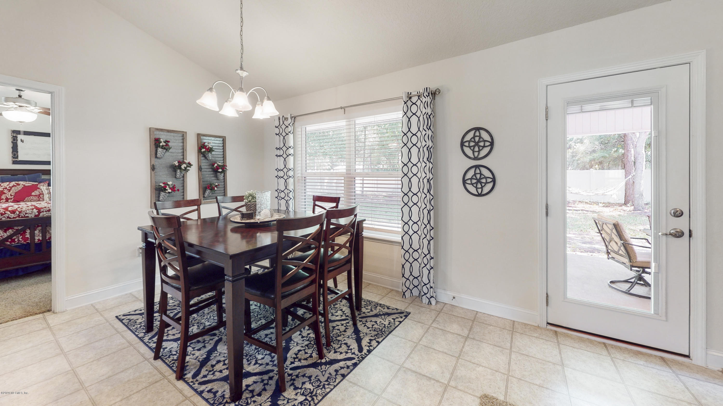 88101 Maybourne Road Yulee, FL 32097 - Photo 9 of 22 a view of a dining room with furniture and chandelier