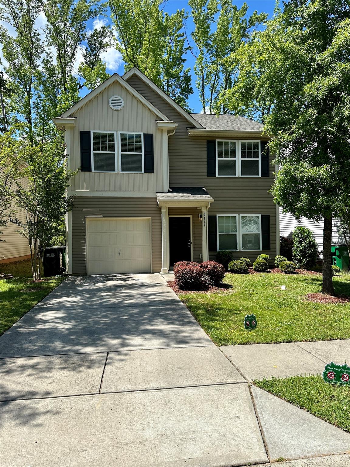 5513 Idlewild Road North Charlotte, NC 28227 - Photo 1 of 18 a front view of a house with a yard and trees