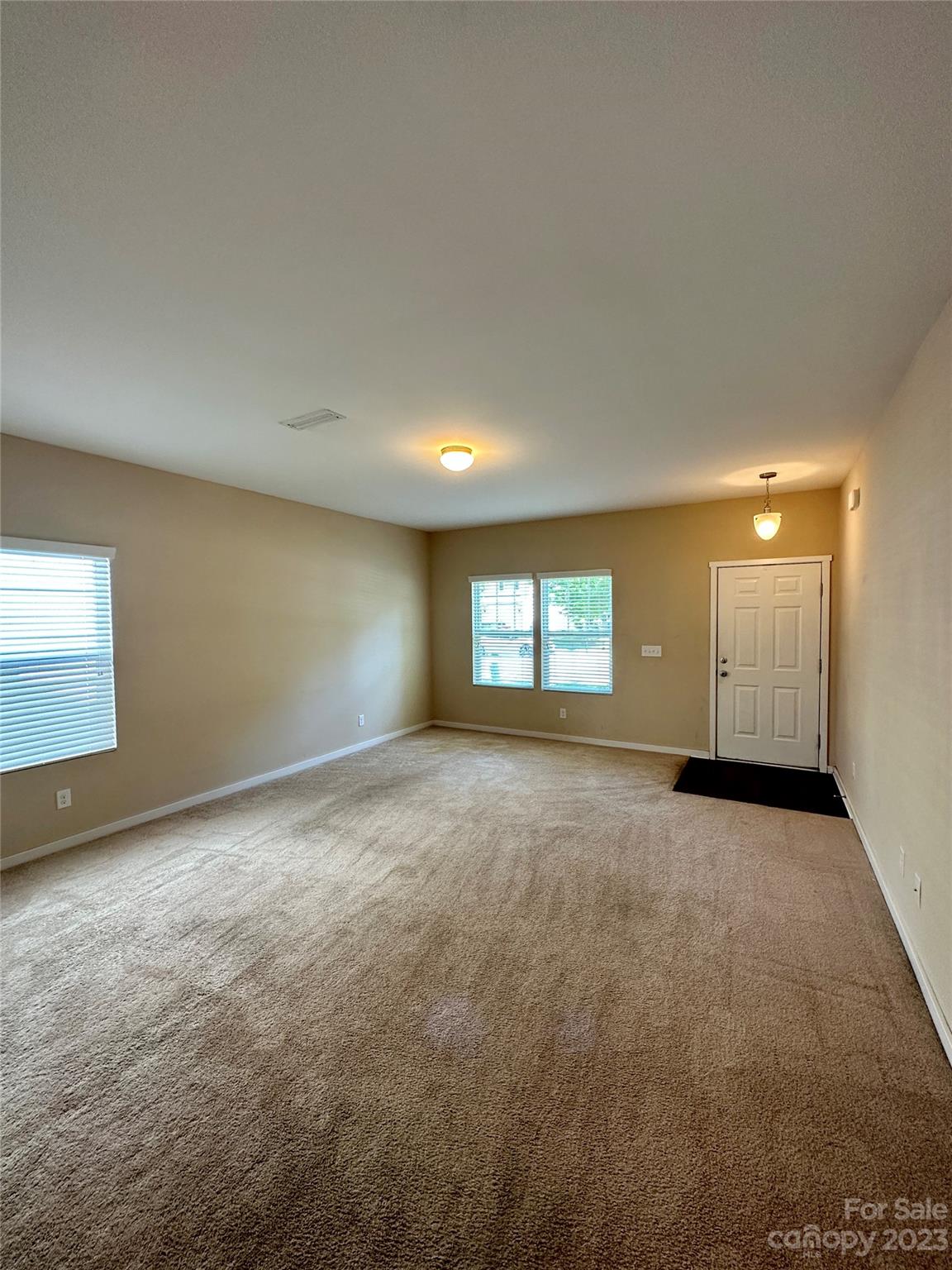5513 Idlewild Road North Charlotte, NC 28227 - Photo 4 of 18 an empty room with windows and closet