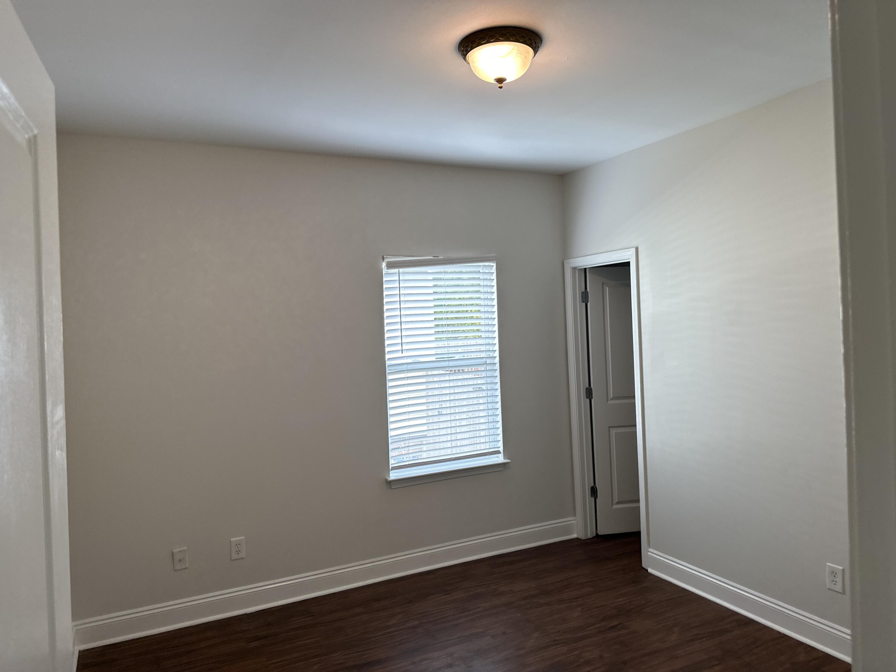 261 County Line Road Niceville, FL 32578 - Photo 12 of 17 an empty room with wooden floor and windows