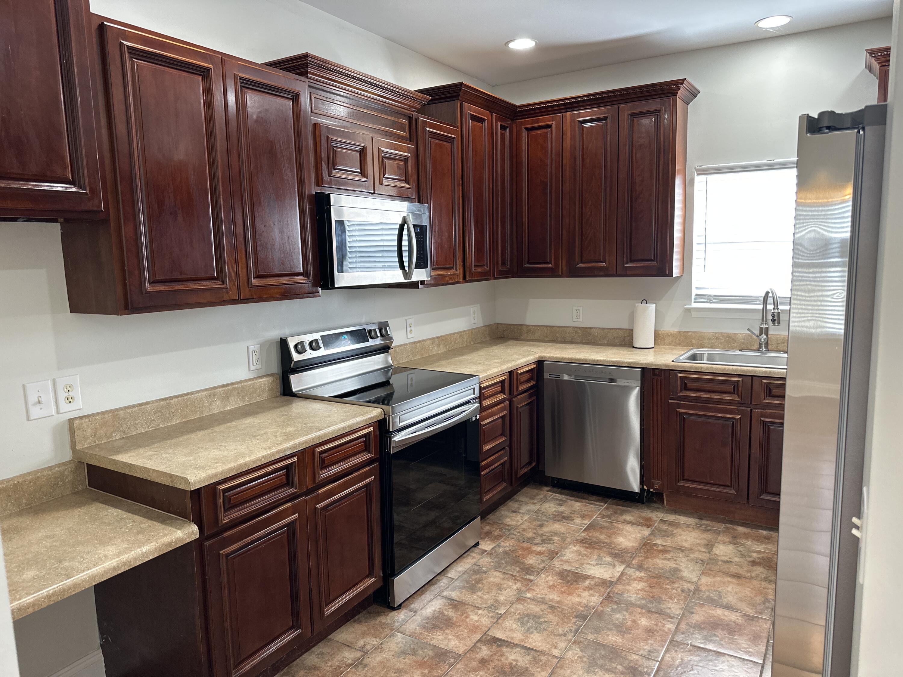 261 County Line Road Niceville, FL 32578 - Photo 15 of 17 a kitchen with a sink stove top oven and cabinets