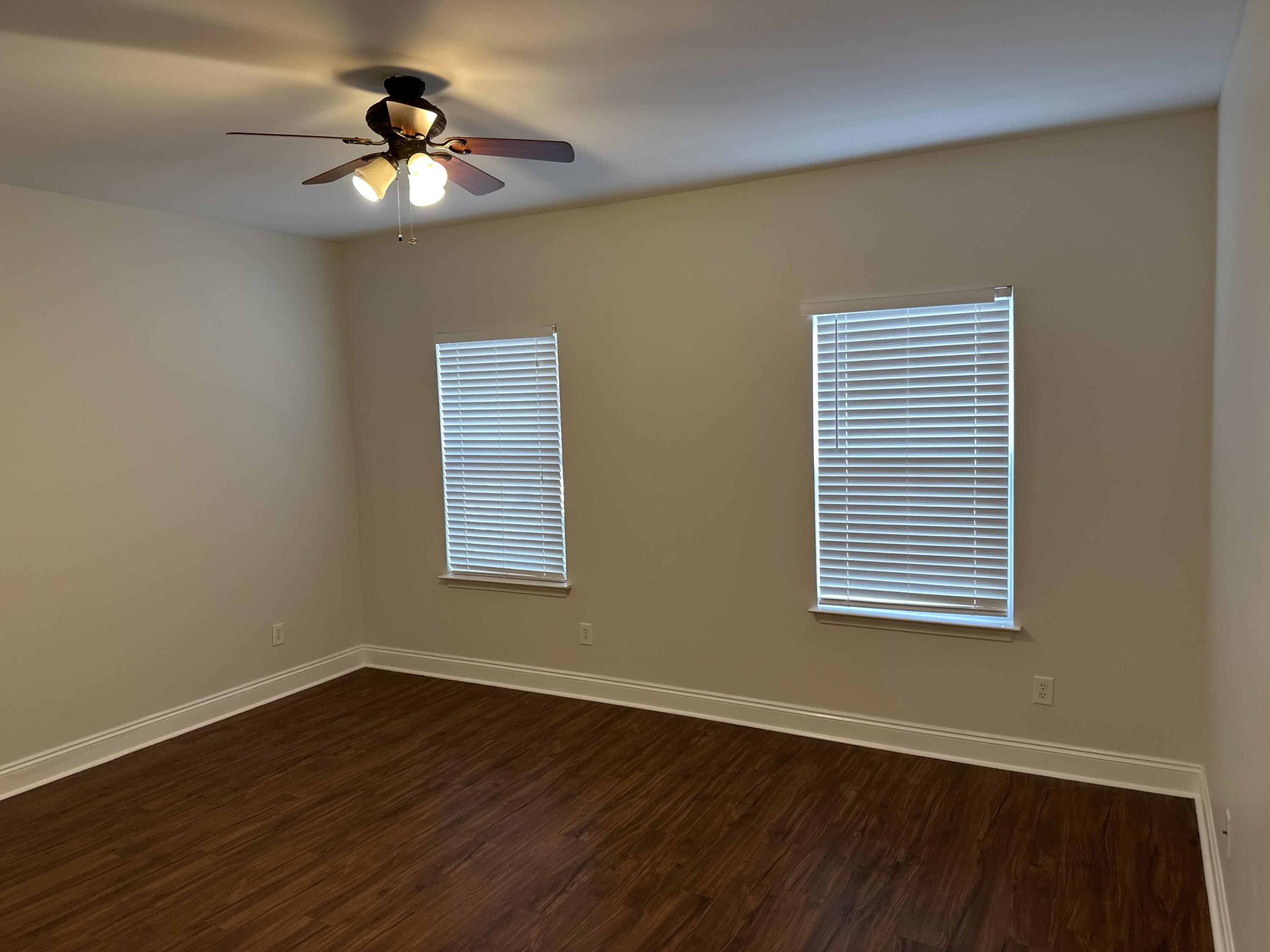 261 County Line Road Niceville, FL 32578 - Photo 6 of 17 a view of an empty room with wooden floor and a window