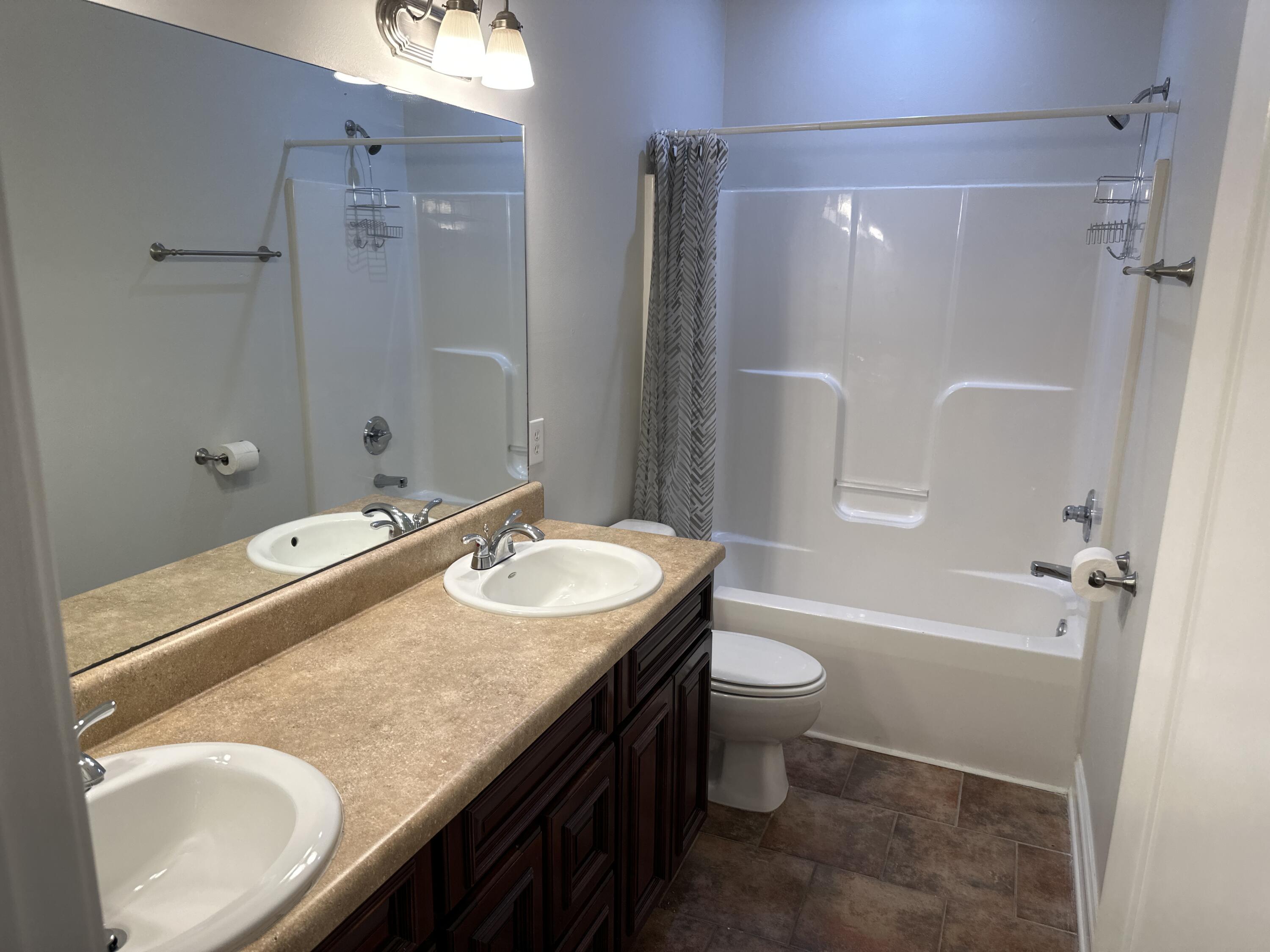 261 County Line Road Niceville, FL 32578 - Photo 7 of 17 a bathroom with a granite countertop sink toilet and shower