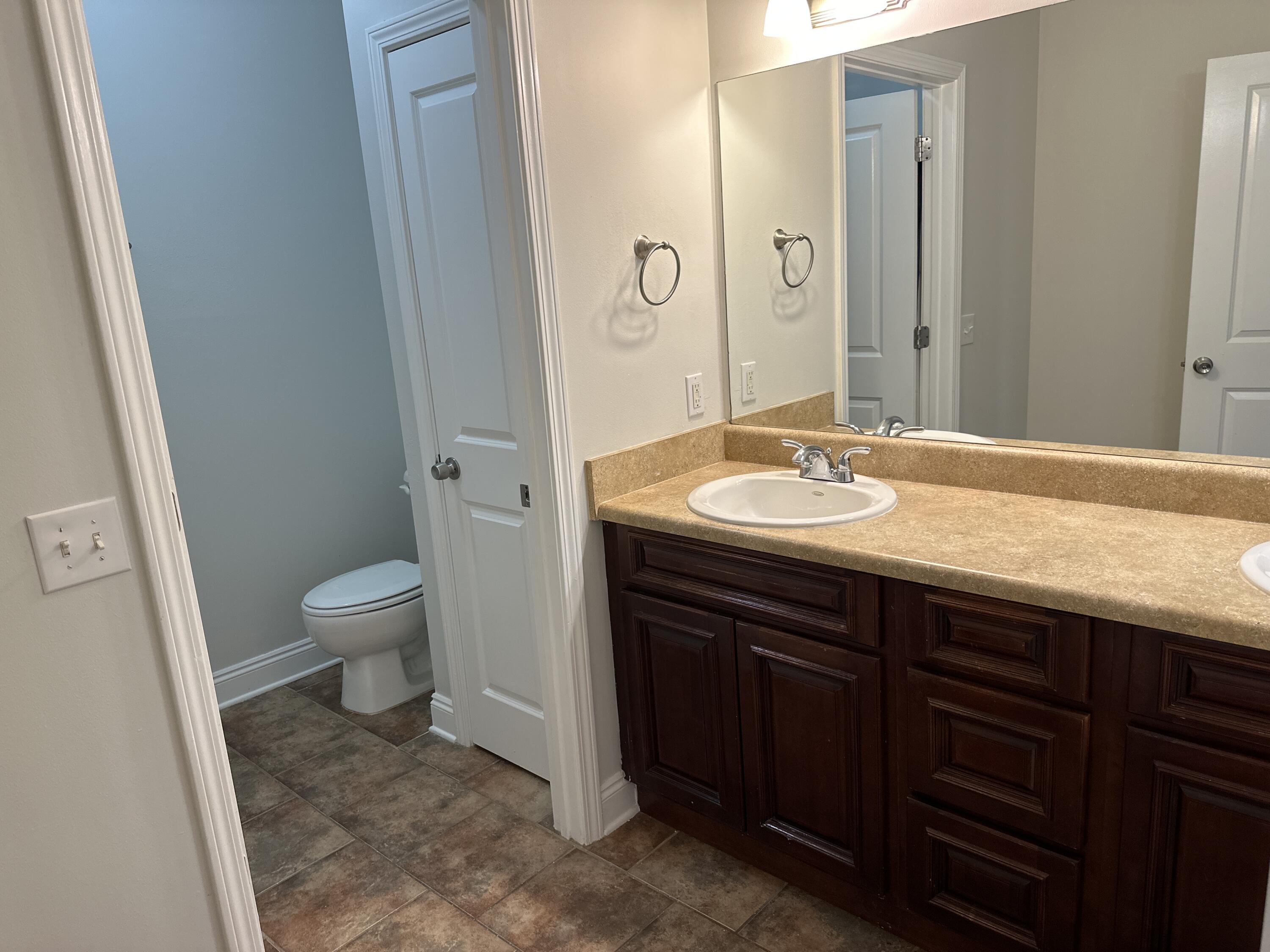 261 County Line Road Niceville, FL 32578 - Photo 9 of 17 a bathroom with a granite countertop sink toilet and shower