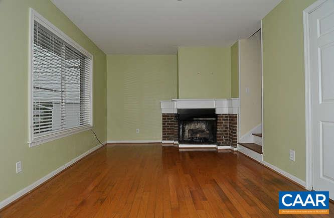 409A Valley Rd Extension Charlottesville, VA 22903 - Photo 4 of 22 a view of a livingroom with wooden floor a fireplace and window