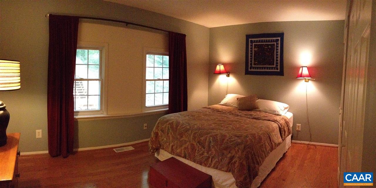 409A Valley Rd Extension Charlottesville, VA 22903 - Photo 10 of 22 a bed sitting in a bedroom next to a window