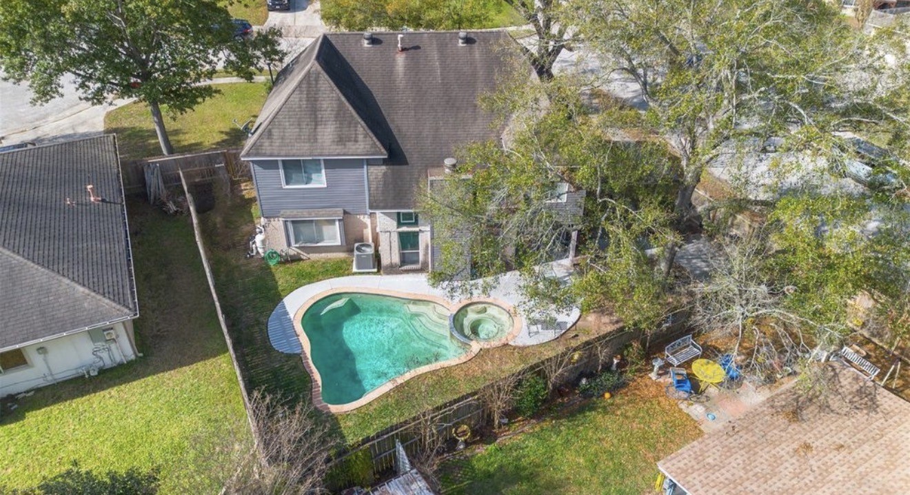 an aerial view of a house with swimming pool garden and patio