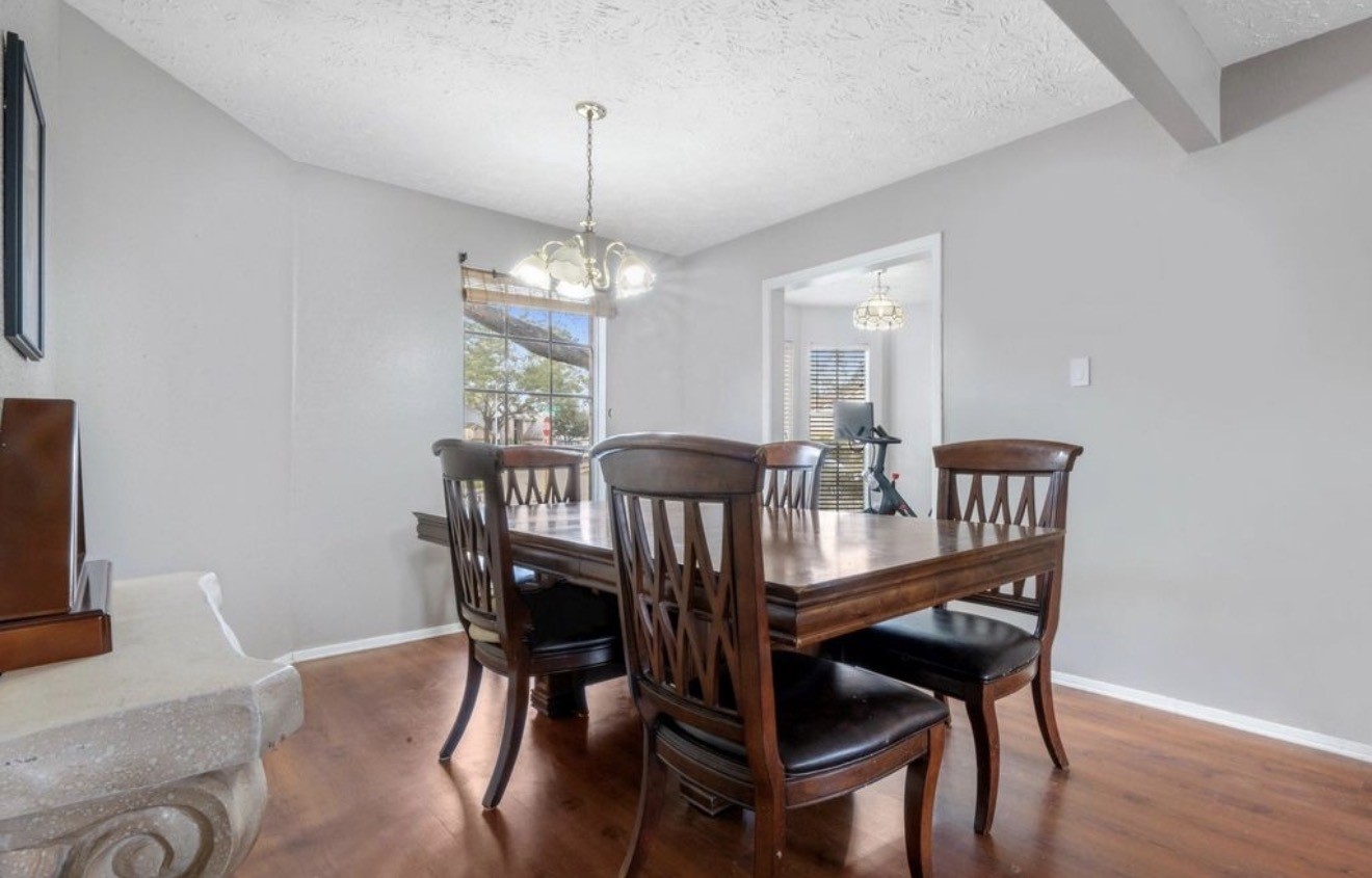 17314 Edenbridge Court Spring, TX 77379 - Photo 11 of 33 a view of a dining room with furniture wooden floor and chandelier