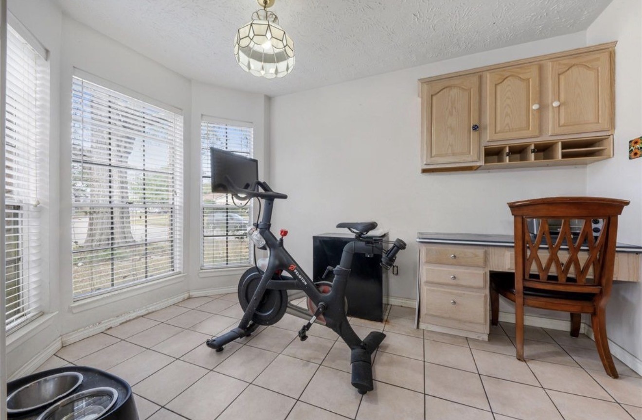 17314 Edenbridge Court Spring, TX 77379 - Photo 12 of 33 a view of a workspace with furniture and a window