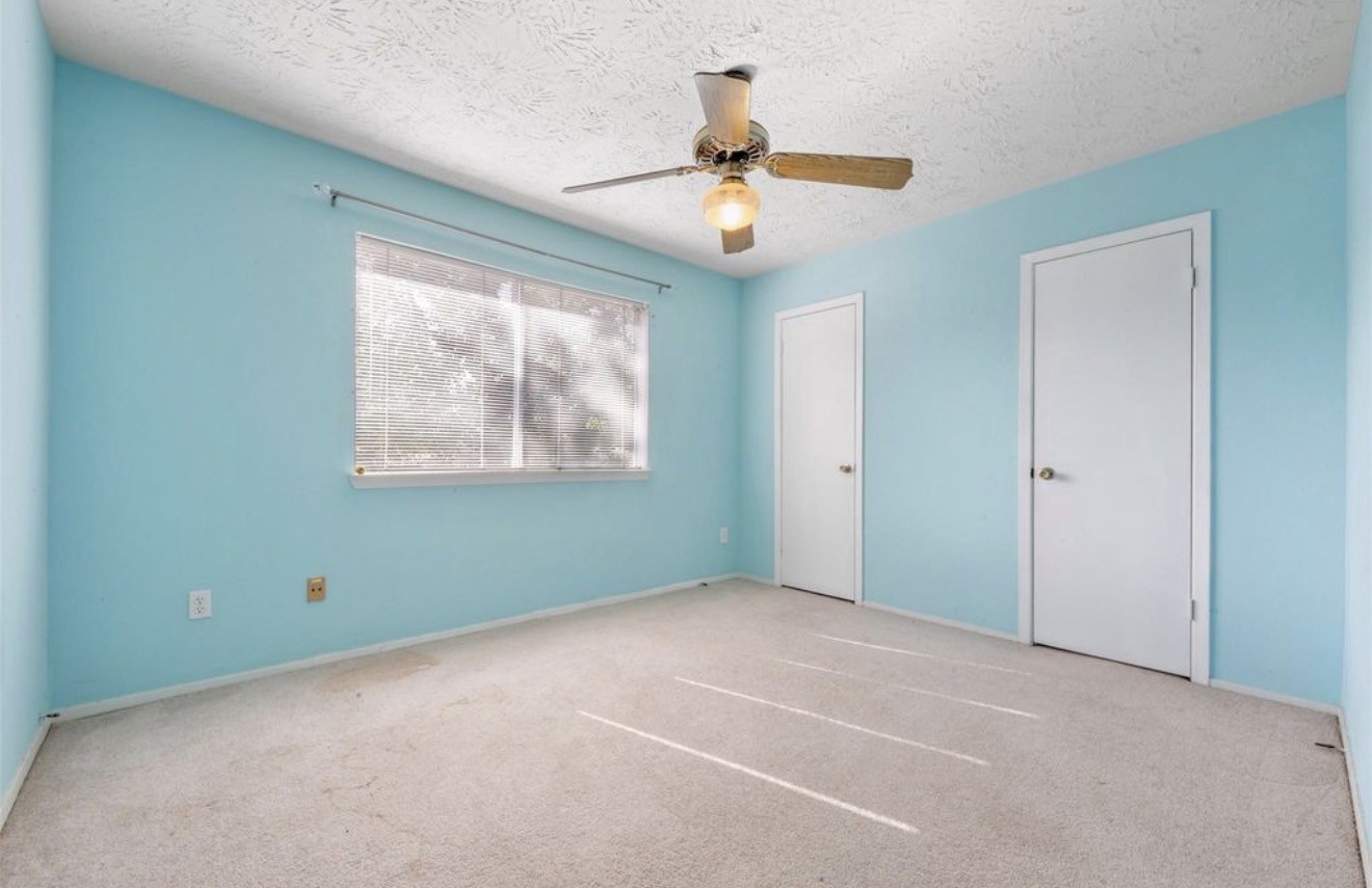 17314 Edenbridge Court Spring, TX 77379 - Photo 23 of 33 an empty room with windows and fan