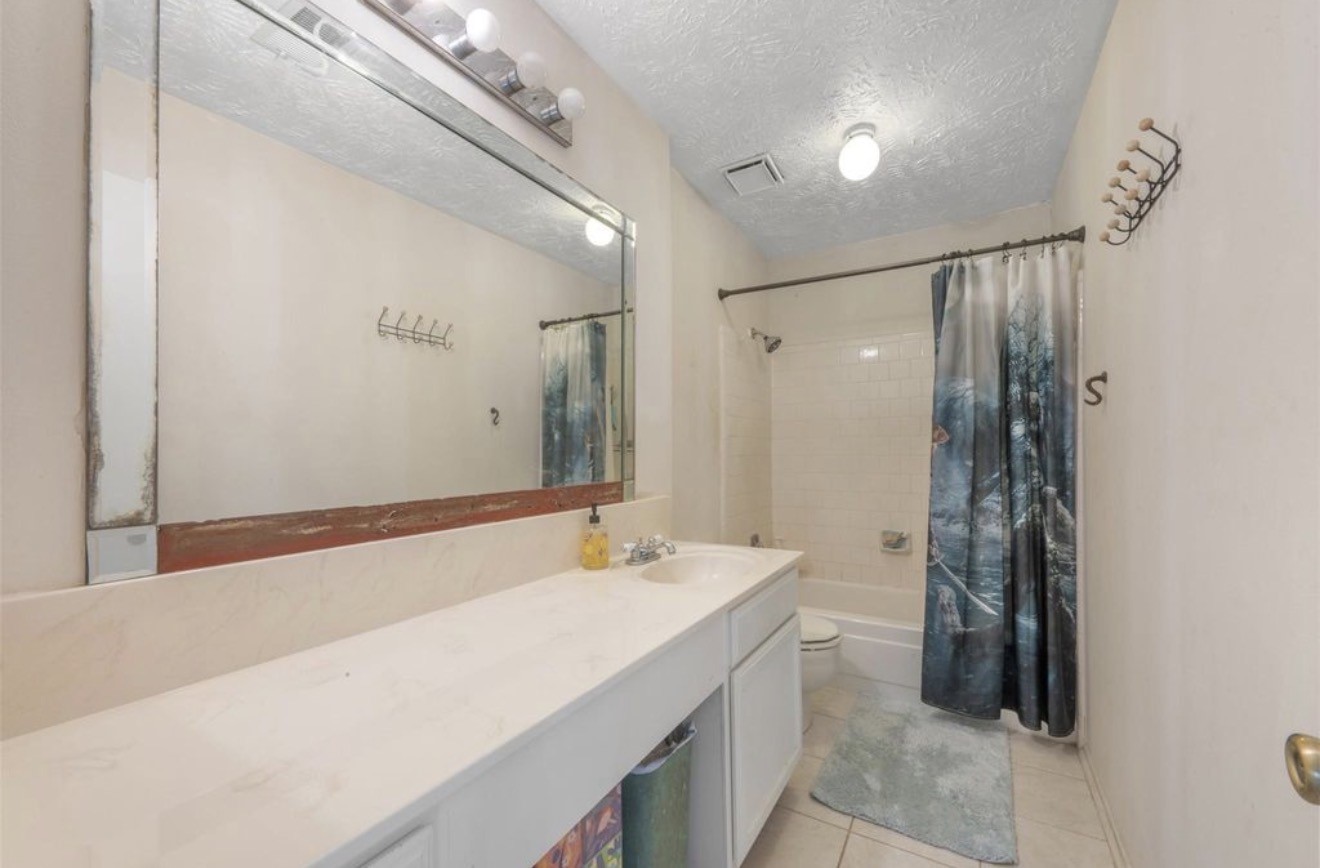 17314 Edenbridge Court Spring, TX 77379 - Photo 25 of 33 a bathroom with a sink a toilet and shower