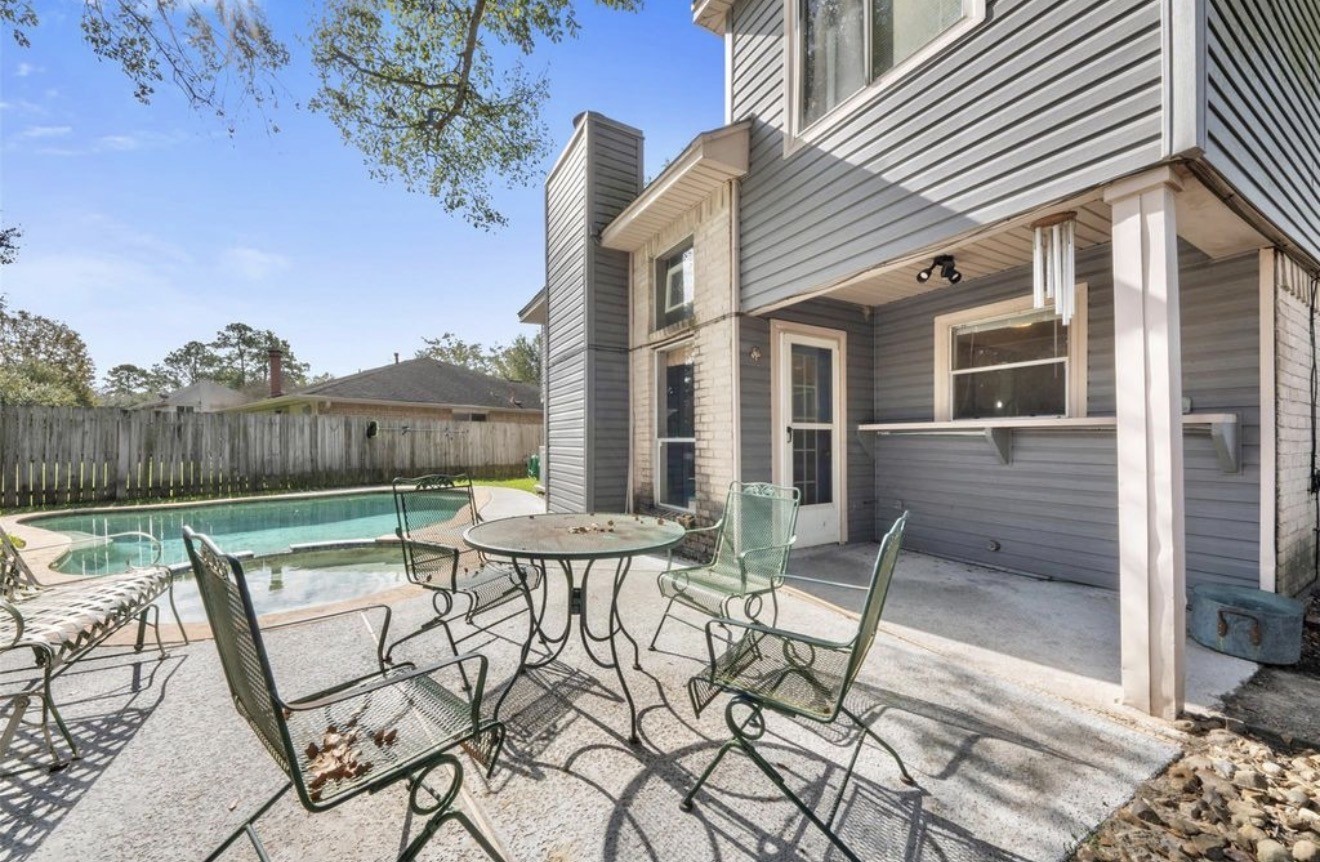 17314 Edenbridge Court Spring, TX 77379 - Photo 27 of 33 a view of a patio with table and chairs and wooden fence
