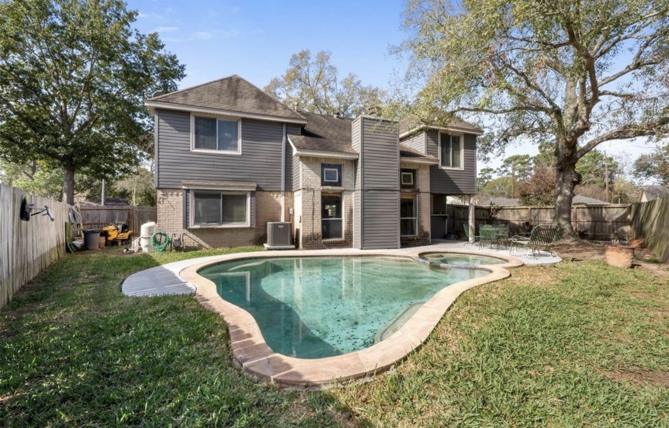 17314 Edenbridge Court Spring, TX 77379 - Photo 28 of 33 a view of a house with swimming pool and a yard